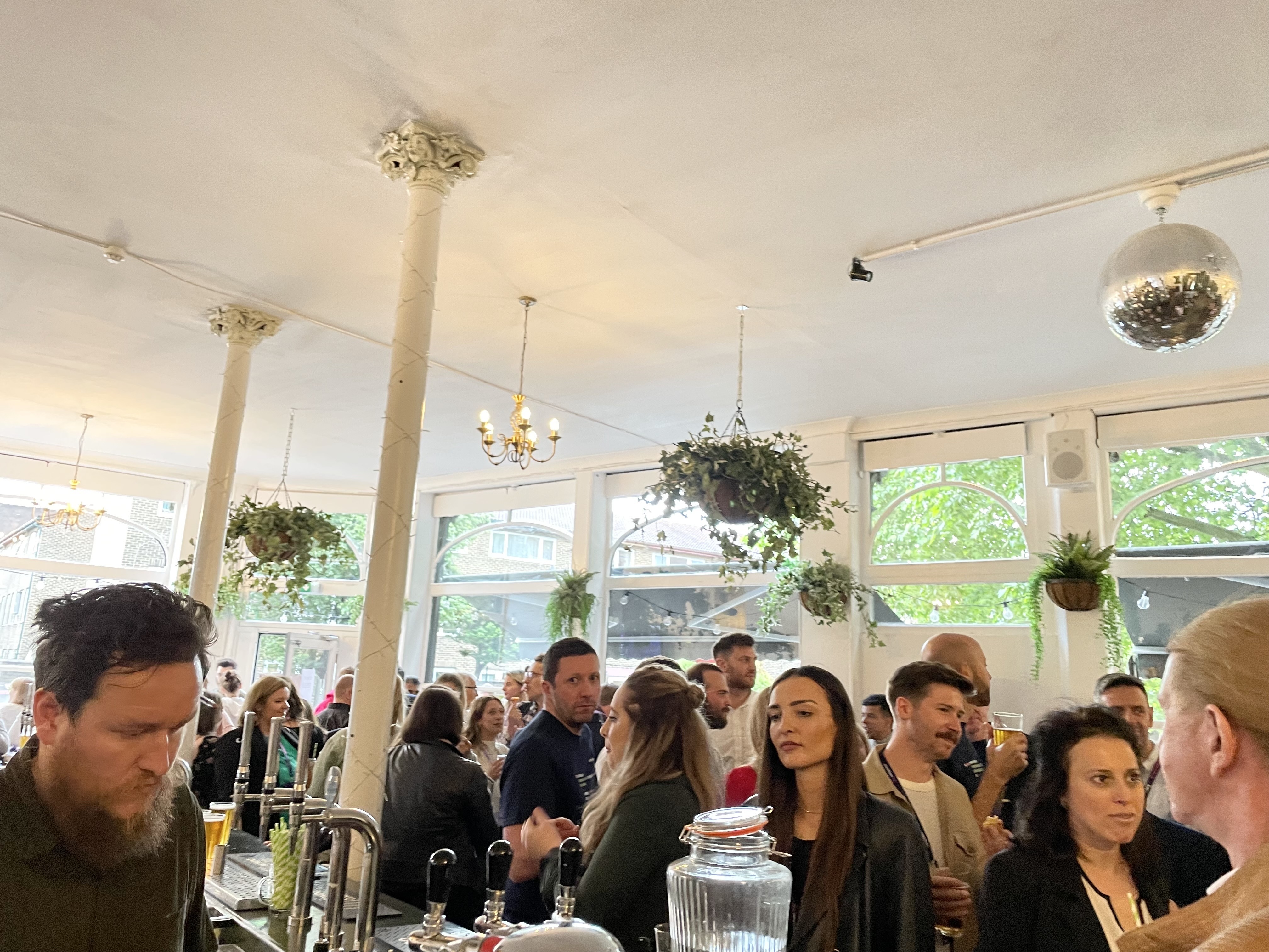 Guests chat around the bar at our afterparty