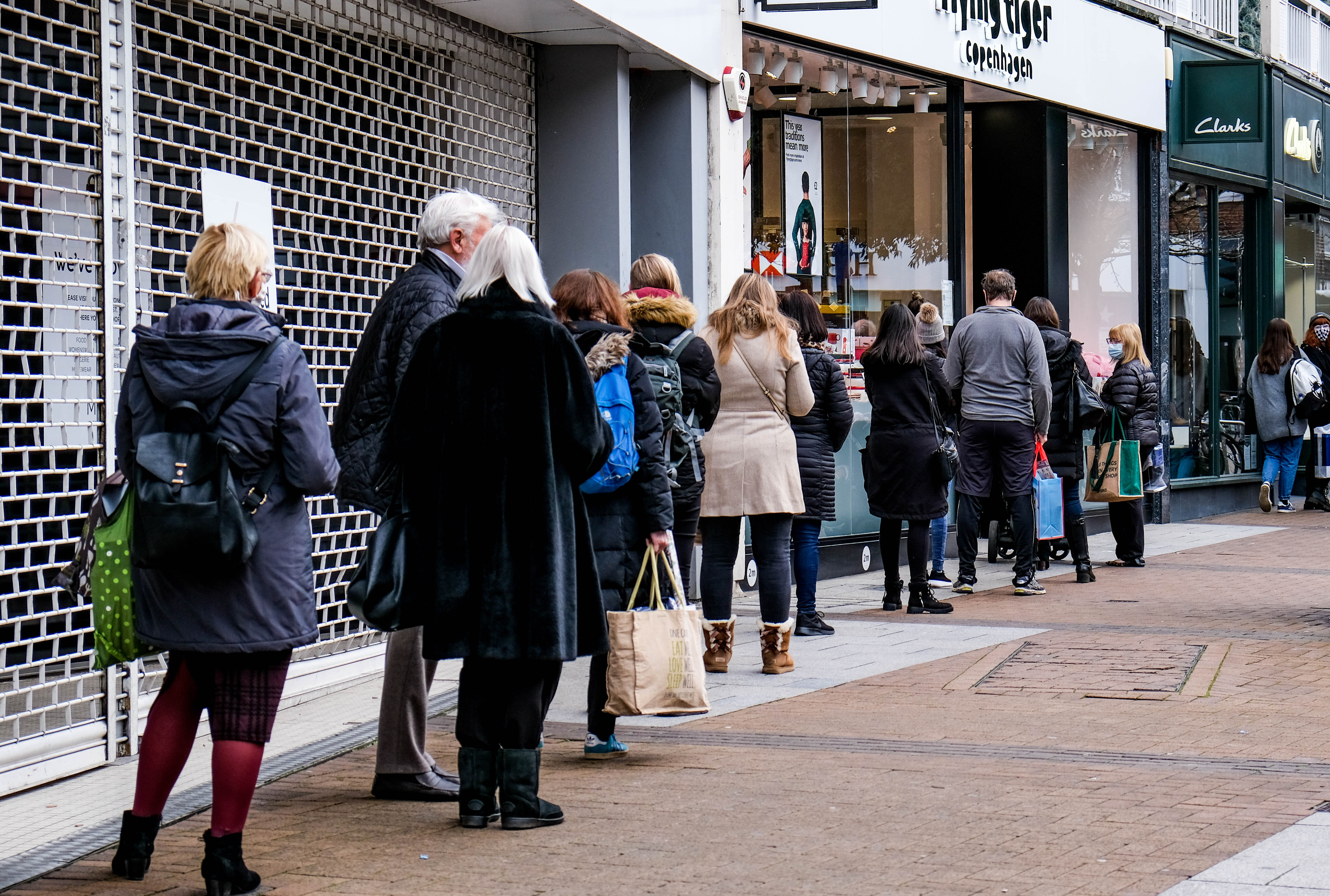 shoppers queue before retail digital transformation
