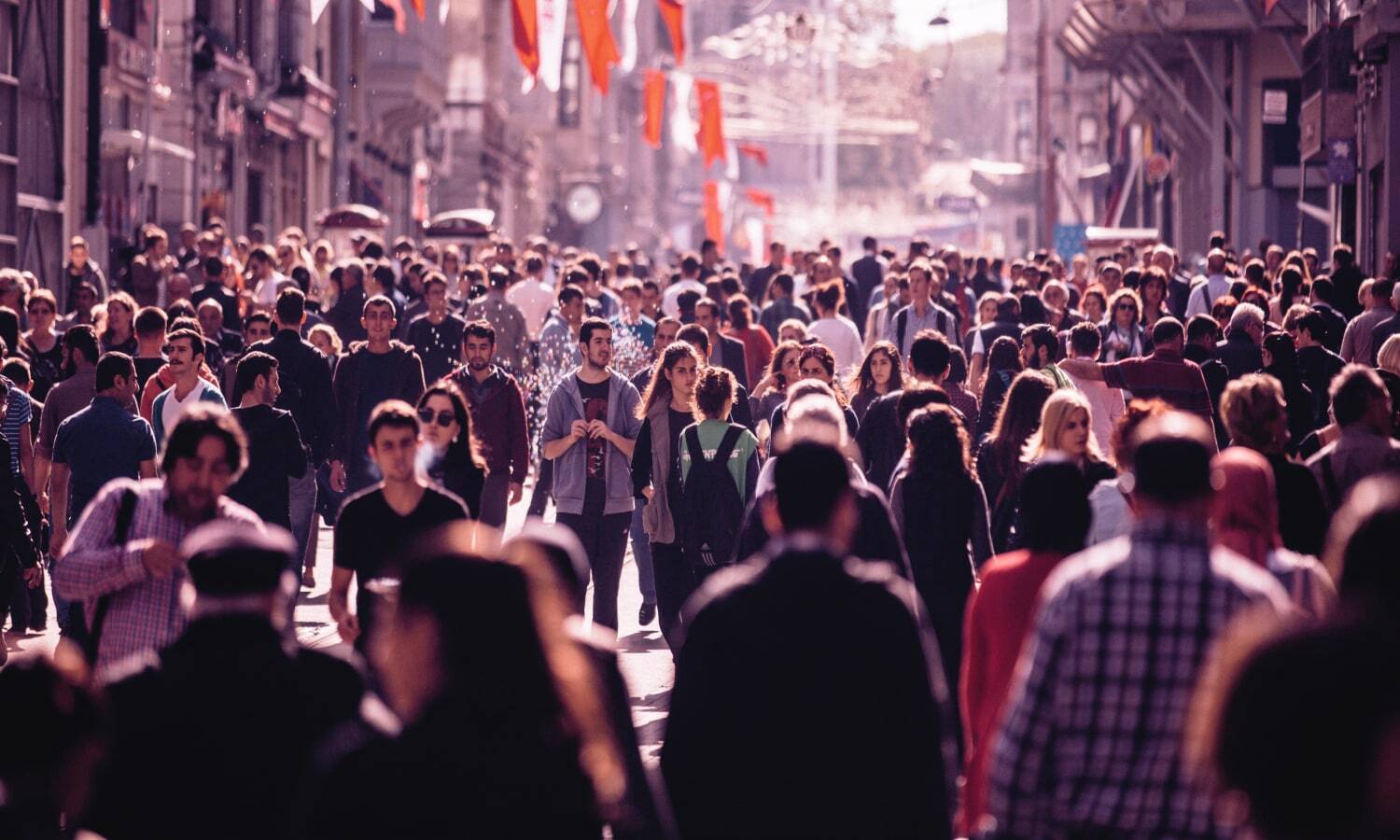 Photograph of people walking down a busy street